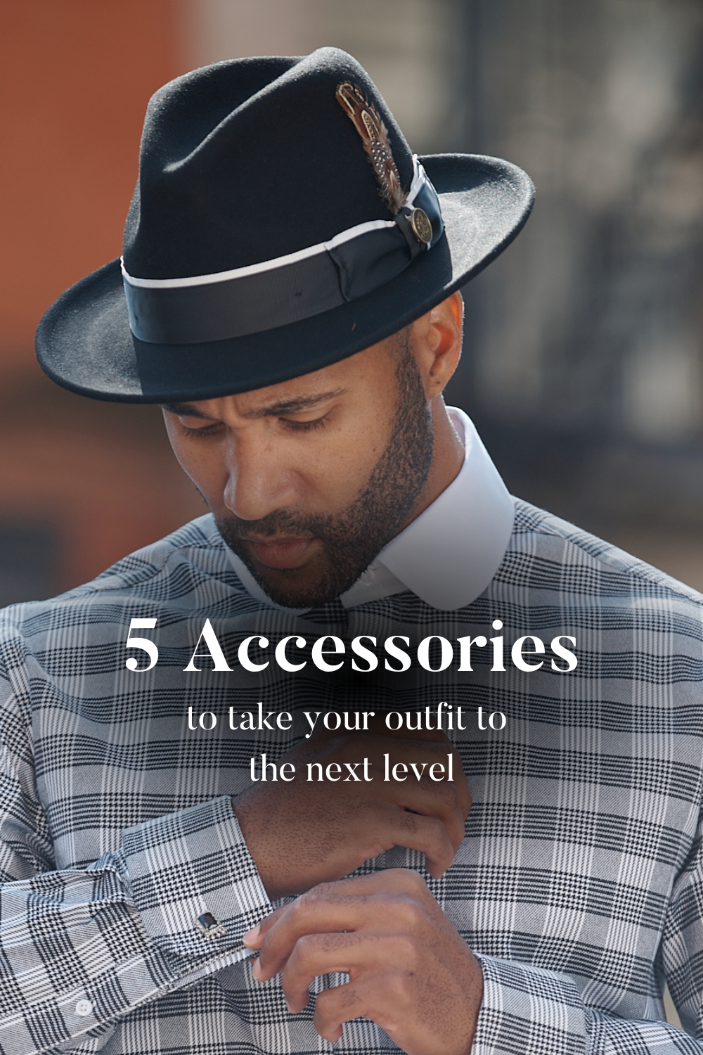 Image of man wearing black fedora hat with overlay text that reads: 5 Accessories to take your outfit to the next level