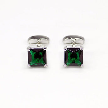 Men's luxury cufflinks with emerald green gem stone set in silver frame.