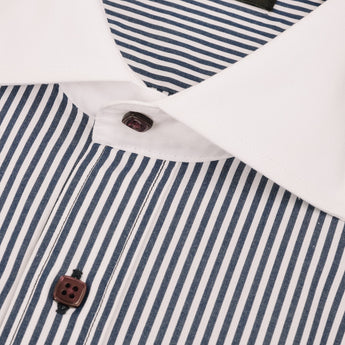 Close up of dress shirt's solid white collar contrasting with navy stripes