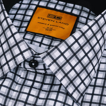 Close up of black plaid pattern on men's dress shirt classic collar